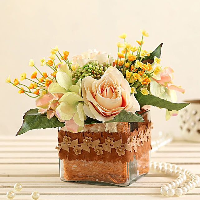 yellow artificial flowers in vase